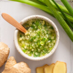 A small dip bowl of ginger scallion sauce.