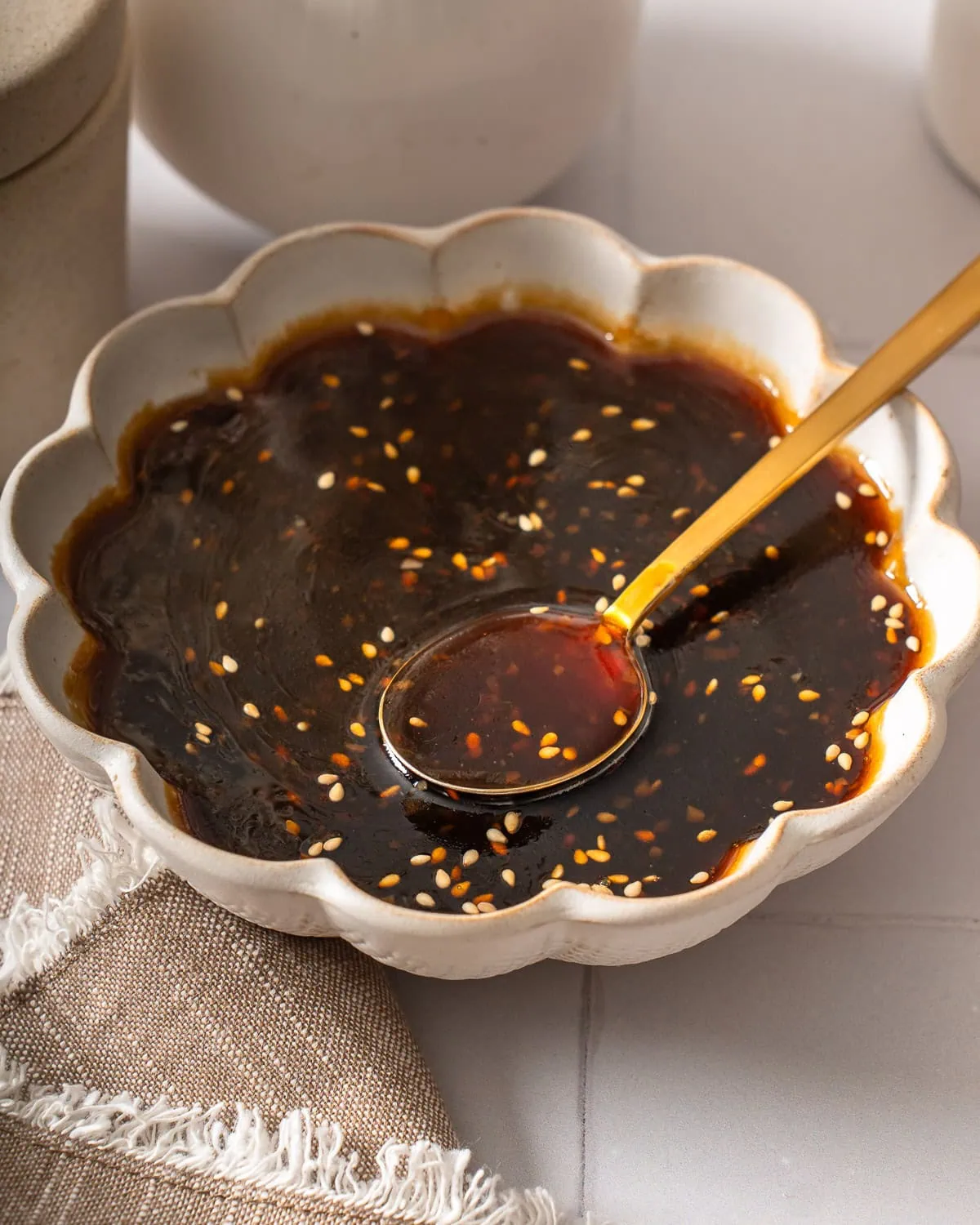 A bowl of teriyaki sauce with a serving spoon.