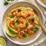 A top down view of a plate of Thai Green curry risotto with a spoon in it.