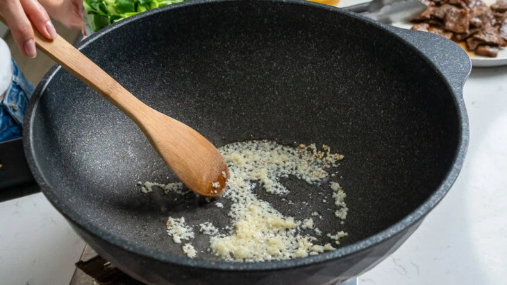 Cooking aromatics in a wok.