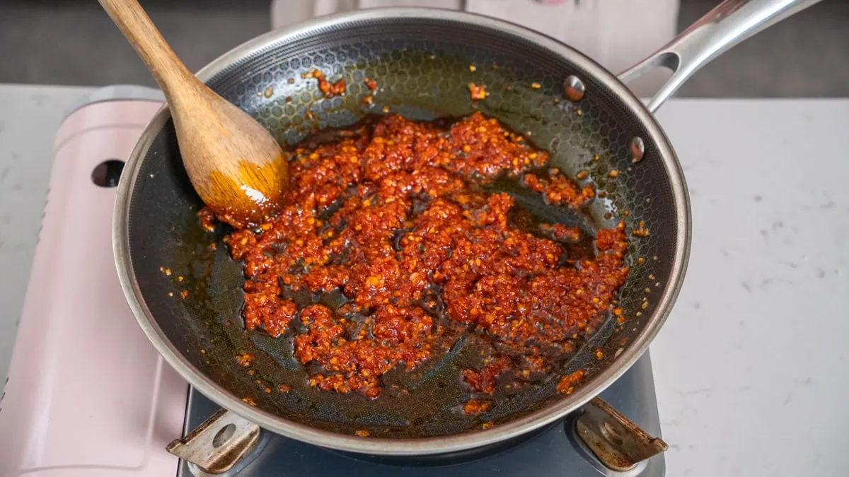 Cooking gochujang paste with aromatics.