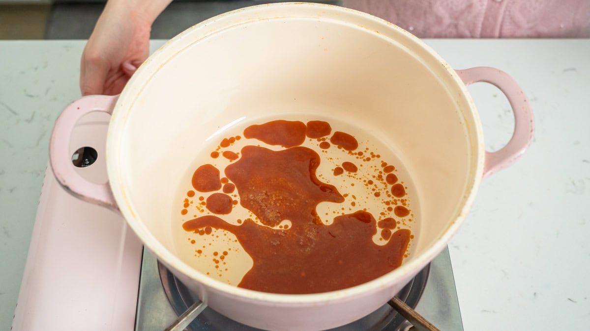 Rock sugar starting to melt and caramelize in a braising pan.