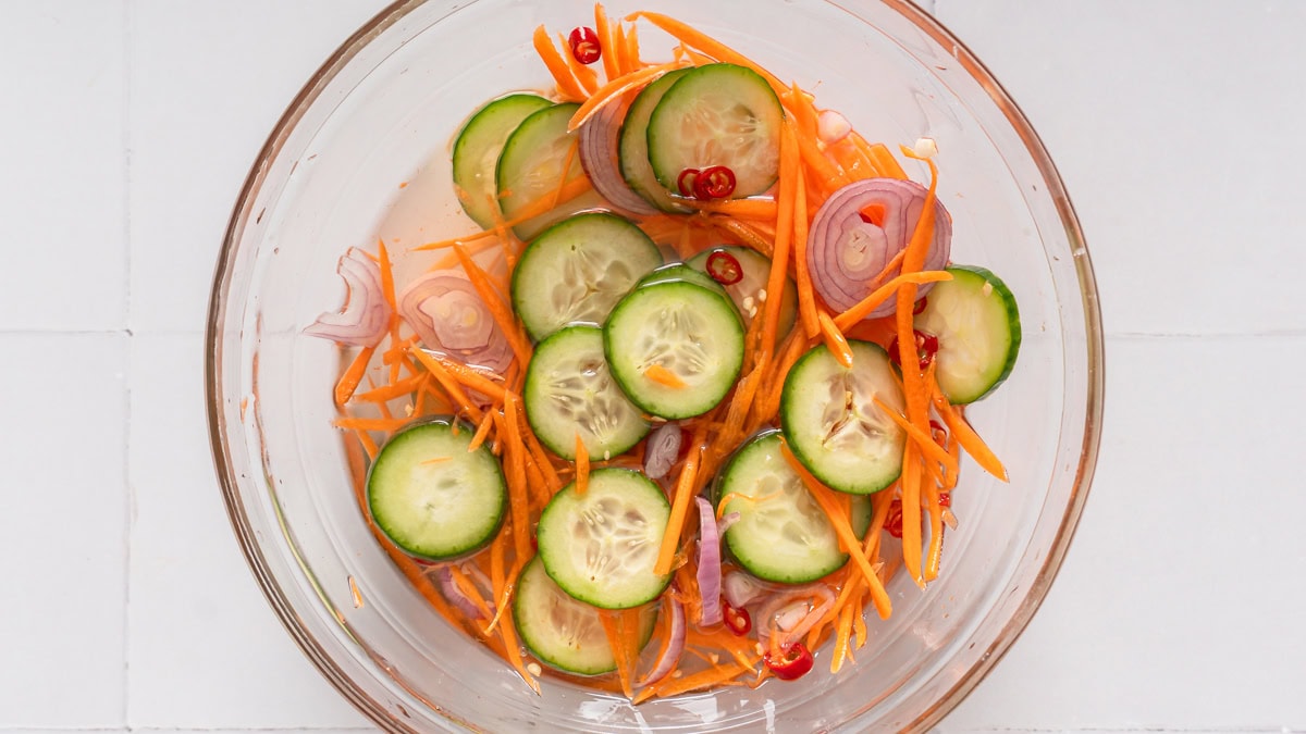 A Thai cucumber relish mixed together in a bowl pickling.