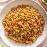 A top down view of platter of Chinese chicken fried rice on a table.