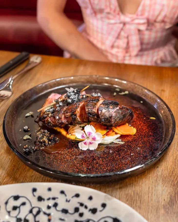 Roasted duck breast presented on a plate.